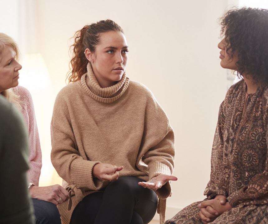 woman in sweater talking to family